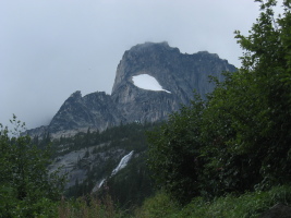 Snowpatch spire with the roof of the hut slightly visible.  Pouring rain on us...