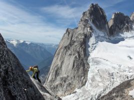 me scrambling along the ridge with the Howsers in the background, photo by Dow Williams