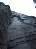 Fiddling with gear at the 5.10b roof