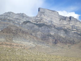 Notch Peak. The north face is the vertical face in the shade (most of it obscured from view from this angle). If you look closely you can see the dirt road we have to drive up!