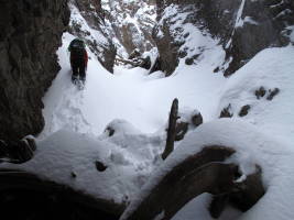 More fun in the gully. The crux is avoiding the open pools of water under the snow! We fell through a few times...